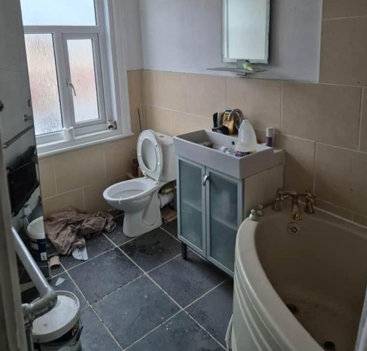 A bathroom damaged by fire and smoke before restoration